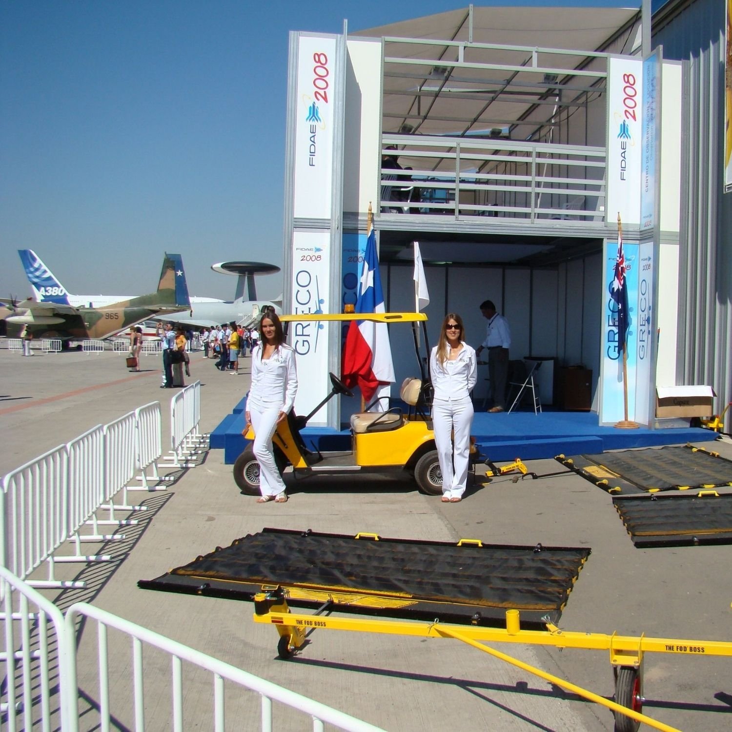 women posing near FOD BOSS runway sweepers