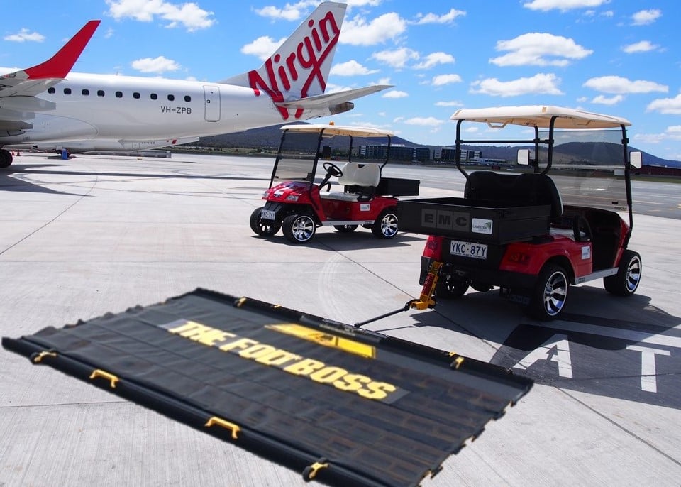 Aerosweep Fod Boss being towed by golf cart at airport